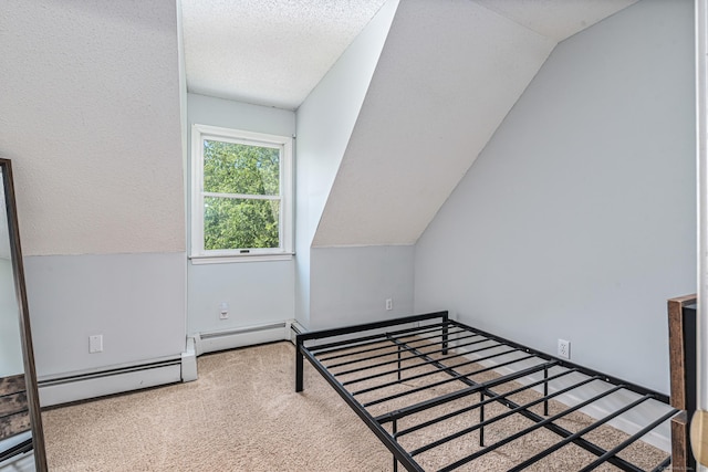 15 Brittany Dr, Durham, CT 06422 - unfurnished bedroom featuring carpet flooring, a baseboard heating unit, vaulted ceiling, and a textured ceiling