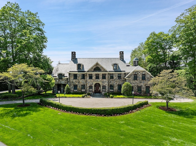 61 High Ridge Ave, Ridgefield, CT 06877 - view of front of property featuring stone siding, a chimney, and a front yard