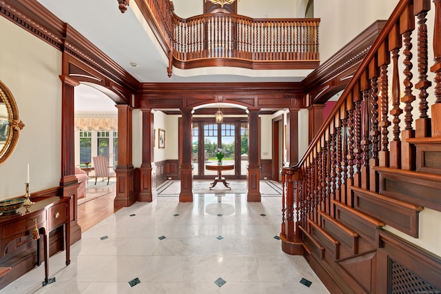 61 High Ridge Ave, Ridgefield, CT 06877 - entrance foyer with ornate columns, a high ceiling, a decorative wall, healthy amount of natural light, and stairs