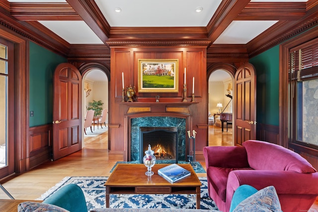 61 High Ridge Ave, Ridgefield, CT 06877 - living area featuring arched walkways, crown molding, light wood-style flooring, a fireplace, and wainscoting