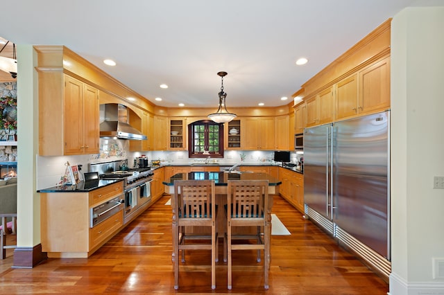 61 High Ridge Ave, Ridgefield, CT 06877 - kitchen with wall chimney range hood, high end appliances, a warming drawer, dark wood-style floors, and an island with sink