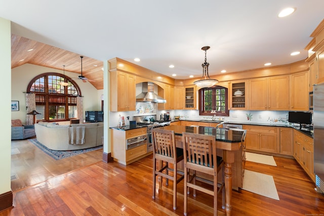 61 High Ridge Ave, Ridgefield, CT 06877 - kitchen with wall chimney range hood, stainless steel appliances, dark countertops, glass insert cabinets, and lofted ceiling