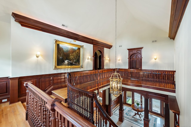 61 High Ridge Ave, Ridgefield, CT 06877 - hall featuring an upstairs landing, a chandelier, a wainscoted wall, high vaulted ceiling, and light wood-style flooring