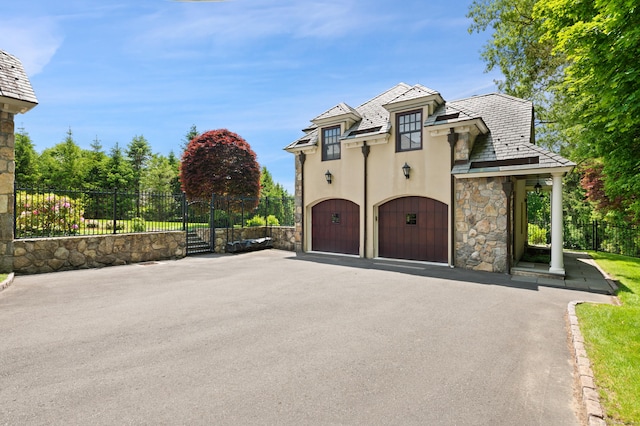 61 High Ridge Ave, Ridgefield, CT 06877 - view of front of property featuring stone siding, stucco siding, a garage, a gate, and asphalt driveway