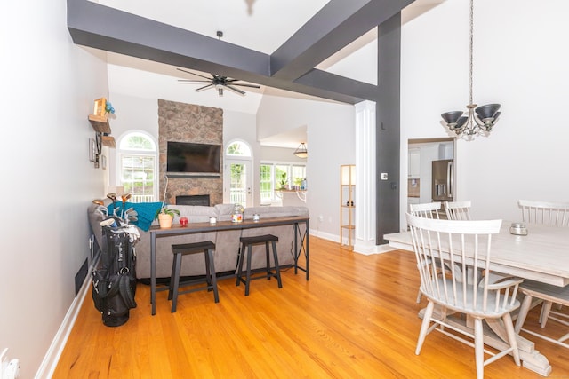 170 Rosewood Ln Unit 170, Berlin, CT 06037 - living area with wood finished floors, a chandelier, high vaulted ceiling, a fireplace, and baseboards