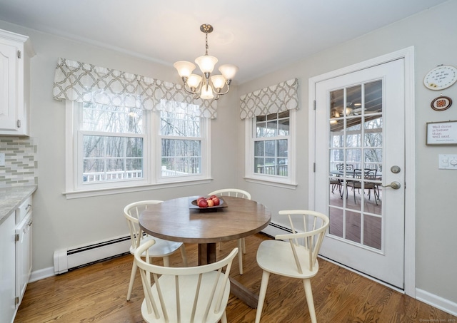 498 Nod Hill Rd, Wilton, CT 06897 - dining room with baseboard heating, a chandelier, wood finished floors, and baseboards