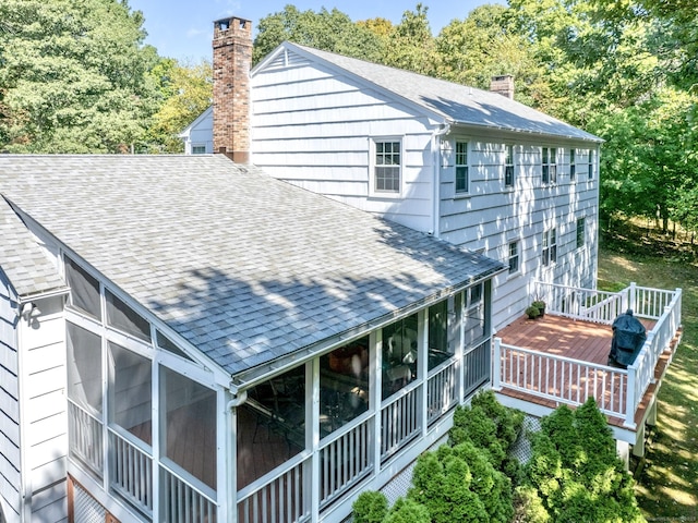 498 Nod Hill Rd, Wilton, CT 06897 - view of home's exterior featuring a chimney, a shingled roof, a sunroom, and a wooden deck