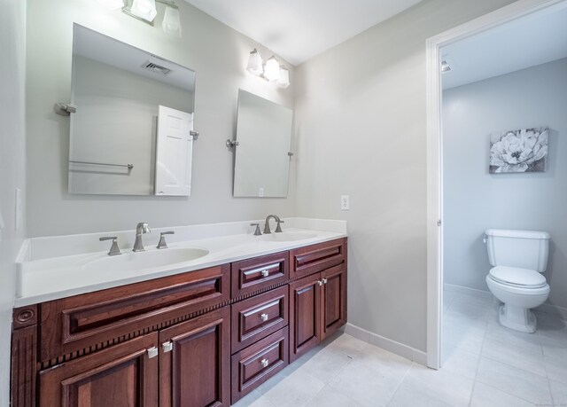 498 Nod Hill Rd, Wilton, CT 06897 - bathroom with double vanity, toilet, baseboards, and tile patterned flooring
