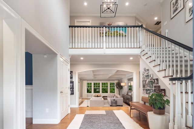 63 Fitch Ln, New Canaan, CT 06840 - foyer entrance featuring arched walkways, wood finished floors, ornamental molding, recessed lighting, and stairway