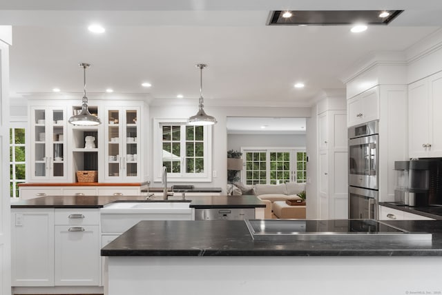 63 Fitch Ln, New Canaan, CT 06840 - kitchen featuring black electric stovetop, white cabinets, double oven, glass insert cabinets, and hanging light fixtures