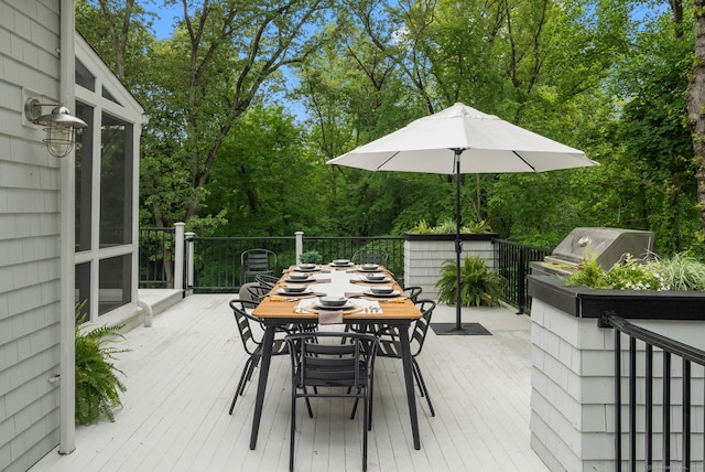 63 Fitch Ln, New Canaan, CT 06840 - wooden deck with outdoor dining space, a grill, and view of scattered trees