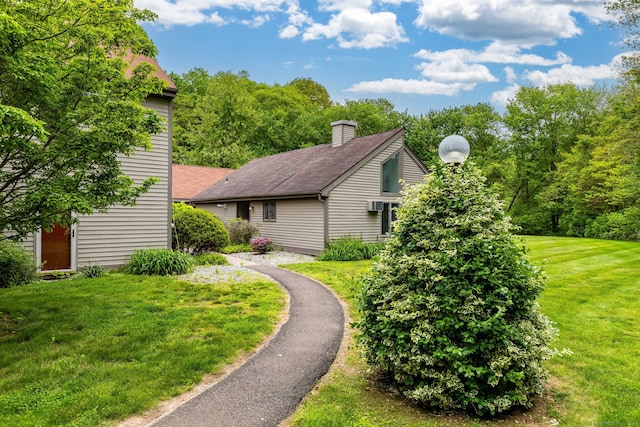 23A Yankee Glen Dr Unit 23A, Madison, CT 06443 - view of side of home featuring a lawn, a chimney, and a shingled roof