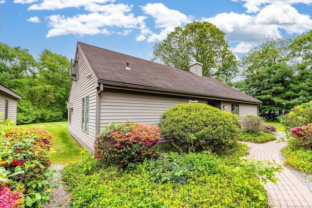 23A Yankee Glen Dr Unit 23A, Madison, CT 06443 - view of side of home with a chimney and roof with shingles