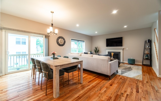 2 Redwood Ln, Southington, CT 06489 - dining room with light wood finished floors, recessed lighting, a chandelier, a glass covered fireplace, and baseboards