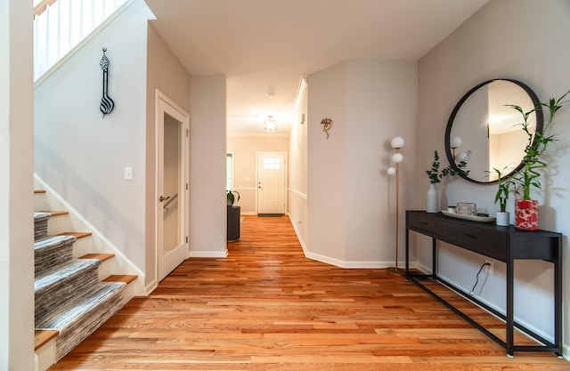 2 Redwood Ln, Southington, CT 06489 - hallway with light wood-type flooring, stairway, and baseboards