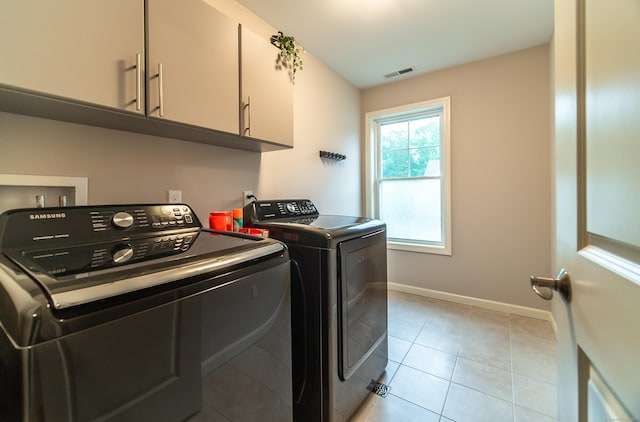 2 Redwood Ln, Southington, CT 06489 - laundry area with cabinet space, washer and clothes dryer, light tile patterned flooring, and baseboards