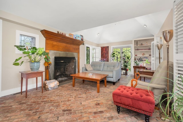 35 Deer Hill Ave, Danbury, CT 06810 - living room featuring vaulted ceiling, a fireplace, baseboards, and brick floors
