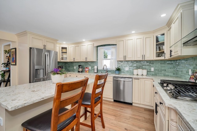 35 Deer Hill Ave, Danbury, CT 06810 - kitchen with stainless steel appliances, cream cabinets, a breakfast bar, light stone countertops, and recessed lighting