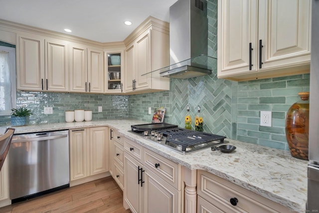 35 Deer Hill Ave, Danbury, CT 06810 - kitchen featuring appliances with stainless steel finishes, wall chimney range hood, cream cabinets, light wood finished floors, and light stone countertops