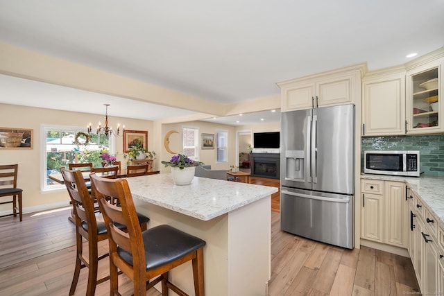 35 Deer Hill Ave, Danbury, CT 06810 - kitchen with appliances with stainless steel finishes, cream cabinetry, light stone counters, a fireplace, and recessed lighting