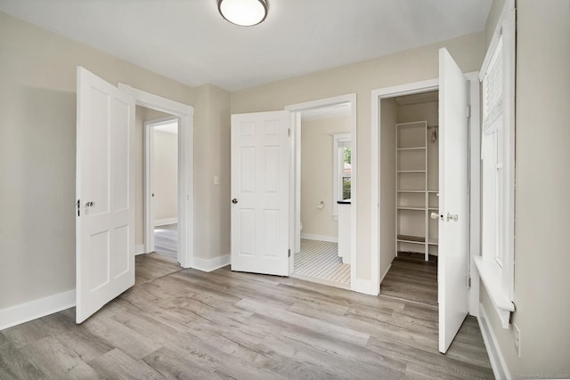 35 Deer Hill Ave, Danbury, CT 06810 - unfurnished bedroom featuring light wood finished floors, baseboards, and connected bathroom