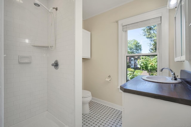 35 Deer Hill Ave, Danbury, CT 06810 - bathroom featuring toilet, vanity, a tile shower, tile patterned floors, and baseboards