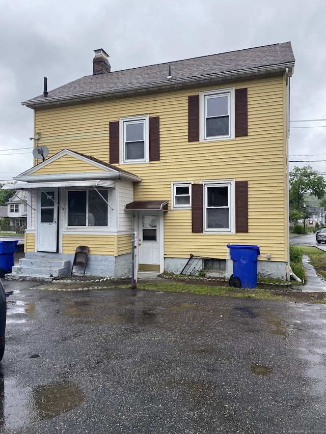624 S Main St, Torrington, CT 06790 - rear view of property with a chimney