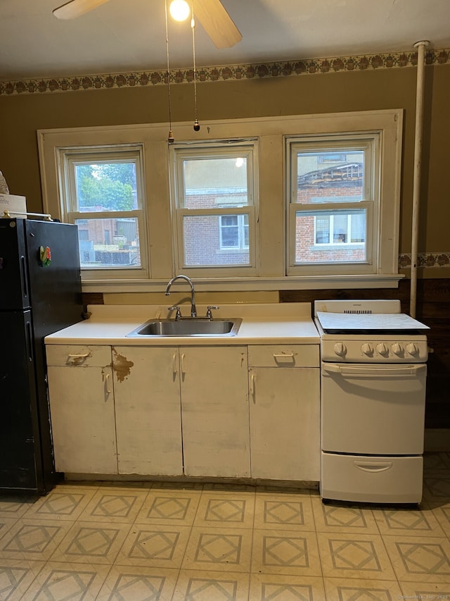 624 S Main St, Torrington, CT 06790 - kitchen featuring white electric stove, a sink, freestanding refrigerator, and light countertops