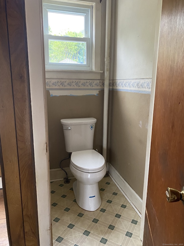 624 S Main St, Torrington, CT 06790 - bathroom featuring toilet, tile patterned floors, baseboards, and wallpapered walls