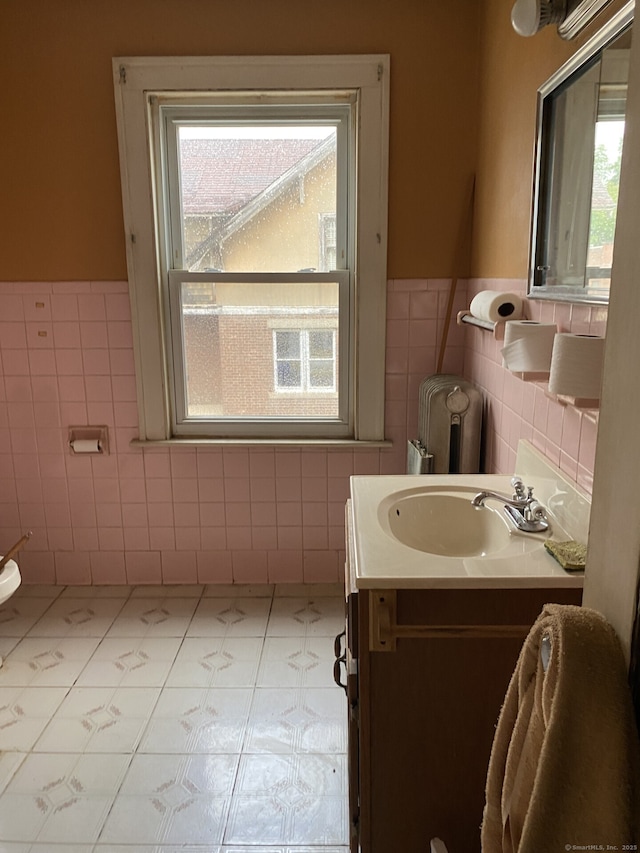 624 S Main St, Torrington, CT 06790 - bathroom with tile walls, vanity, a wainscoted wall, and tile patterned floors