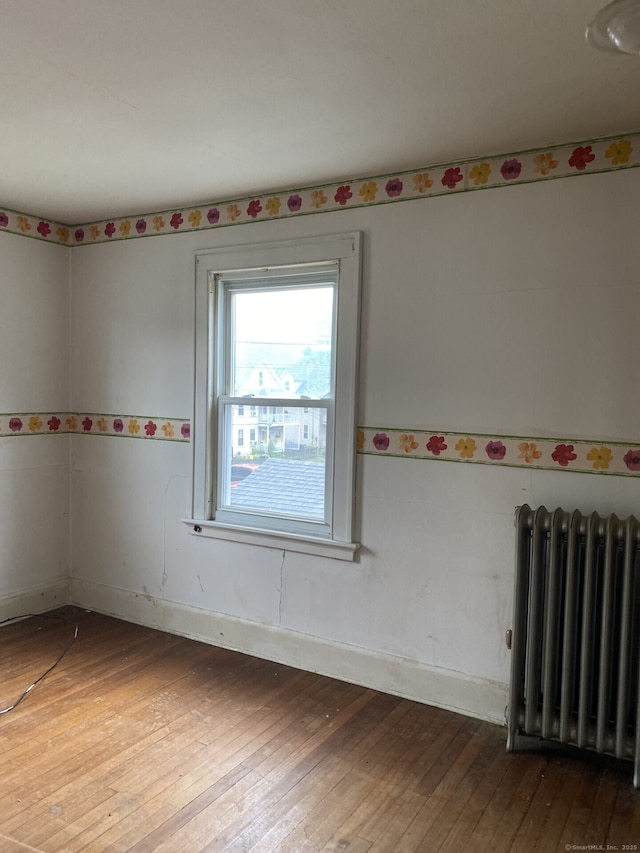 624 S Main St, Torrington, CT 06790 - spare room featuring radiator, wood-type flooring, and baseboards