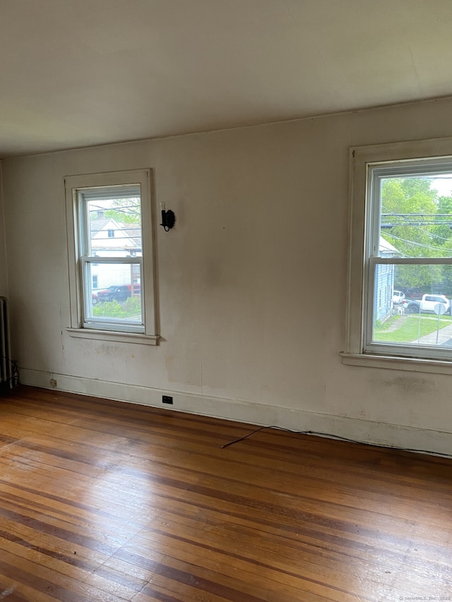 624 S Main St, Torrington, CT 06790 - unfurnished room with plenty of natural light, hardwood / wood-style floors, and radiator