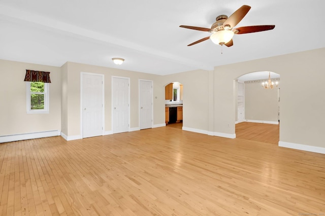 172 S Rd, Marlborough, CT 06447 - unfurnished living room featuring arched walkways, light wood-style floors, and a baseboard radiator