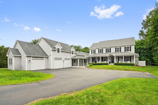 48 Evergreen Rd, Cromwell, CT 06416 - view of front facade featuring covered porch, driveway, a front yard, a garage, and roof with shingles