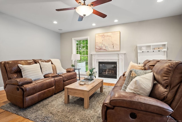 48 Evergreen Rd, Cromwell, CT 06416 - living area featuring wood finished floors, recessed lighting, a fireplace with flush hearth, and ceiling fan