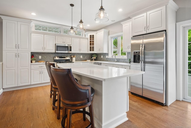 48 Evergreen Rd, Cromwell, CT 06416 - kitchen with appliances with stainless steel finishes, a sink, light wood-style flooring, a center island, and healthy amount of natural light