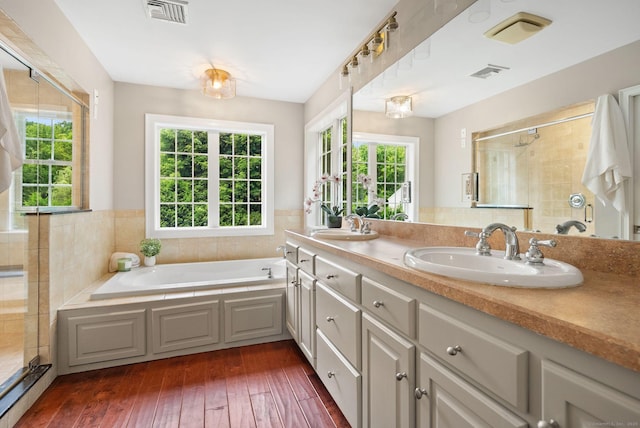 48 Evergreen Rd, Cromwell, CT 06416 - bathroom featuring double vanity, a bath, tiled shower, and hardwood / wood-style floors