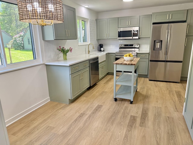 740 Heritage Vlg Unit B, Southbury, CT 06488 - kitchen with appliances with stainless steel finishes, a sink, light countertops, and tasteful backsplash