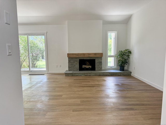 740 Heritage Vlg Unit B, Southbury, CT 06488 - unfurnished living room with plenty of natural light, wood finished floors, and a fireplace