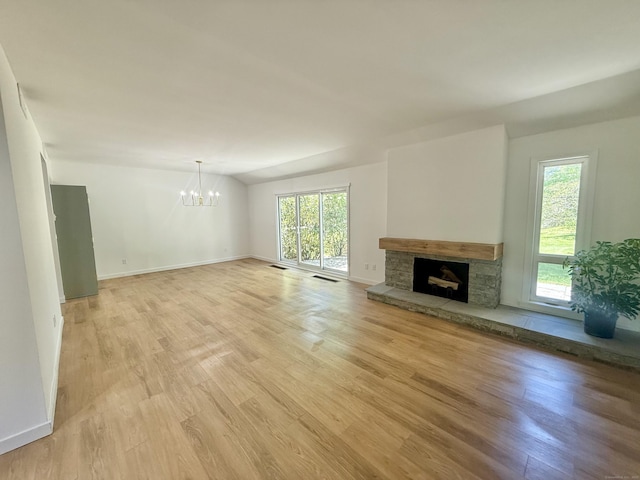740 Heritage Vlg Unit B, Southbury, CT 06488 - unfurnished living room featuring a chandelier, plenty of natural light, a fireplace, light wood-style floors, and lofted ceiling