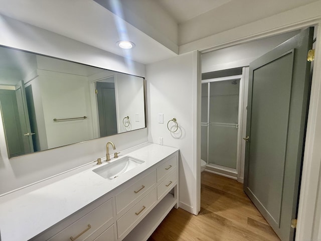 740 Heritage Vlg Unit B, Southbury, CT 06488 - full bath with vanity, wood finished floors, toilet, a stall shower, and baseboards