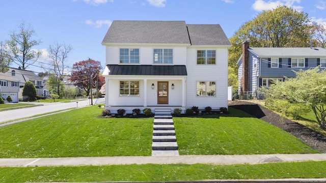 15 Barton Rd, Fairfield, CT 06824 - view of front of home with a standing seam roof, a porch, a front lawn, and metal roof