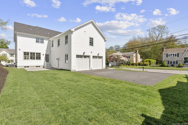 15 Barton Rd, Fairfield, CT 06824 - rear view of house featuring an attached garage, asphalt driveway, entry steps, a yard, and central air condition unit