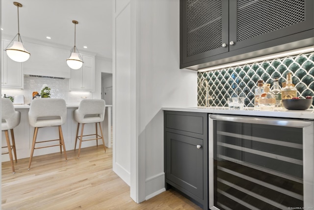 15 Barton Rd, Fairfield, CT 06824 - indoor wet bar with wine cooler, decorative backsplash, light wood-style flooring, decorative light fixtures, and recessed lighting