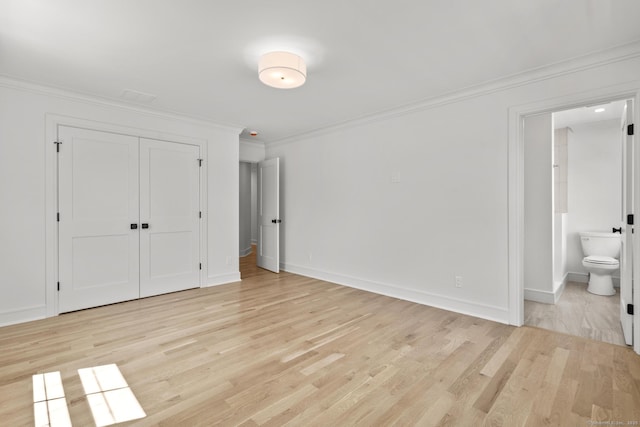 15 Barton Rd, Fairfield, CT 06824 - unfurnished bedroom with ornamental molding, light wood finished floors, ensuite bath, baseboards, and a closet