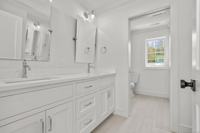 15 Barton Rd, Fairfield, CT 06824 - full bathroom featuring double vanity, toilet, baseboards, and ornamental molding