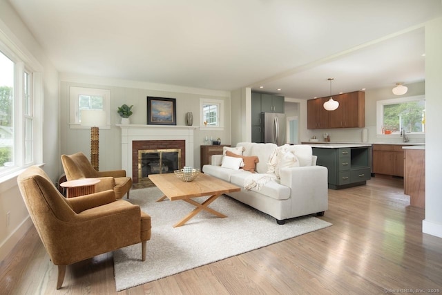 331 Calkinstown Rd, Sharon, CT 06069 - living area featuring a brick fireplace, light wood-type flooring, and baseboards