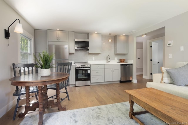 331 Calkinstown Rd, Sharon, CT 06069 - kitchen with appliances with stainless steel finishes, gray cabinetry, light wood-style flooring, decorative backsplash, and baseboards