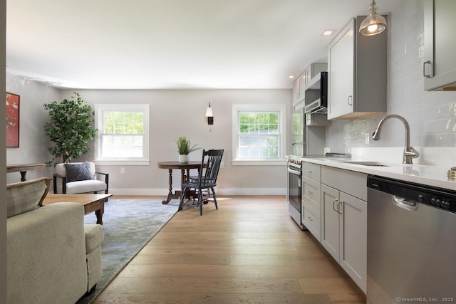 331 Calkinstown Rd, Sharon, CT 06069 - kitchen with appliances with stainless steel finishes, light wood finished floors, backsplash, a sink, and baseboards