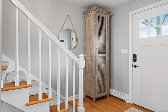 55 Cypress Rd, Old Saybrook, CT 06475 - entrance foyer featuring baseboard heating, stairway, and light wood-style floors